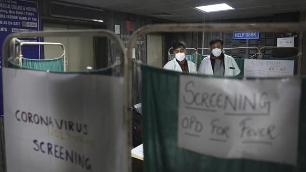Doctors screen a patient for a fever at a hospital in New Delhi. “All major cities abroad take such lockdown measures in case of such a pandemic. The decision to shut movie halls is particularly wise because theatres are a place where people sit in close proximity for prolonged periods. Disinfecting cinema halls becomes all the more difficult because it is dark and gets no sunlight,” said Dr Jugal Kishore, head of the department of community medicine, Safdarjung Hospital. (Manish Swarup / AP) Doctors screen a patient for a fever at a hospital in New Delhi. “All major cities abroad take such lockdown measures in case of such a pandemic. The decision to shut movie halls is particularly wise because theatres are a place where people sit in close proximity for prolonged periods. Disinfecting cinema halls becomes all the more difficult because it is dark and gets no sunlight,” said Dr Jugal Kishore, head of the department of community medicine, Safdarjung Hospital. (Manish Swarup / AP)