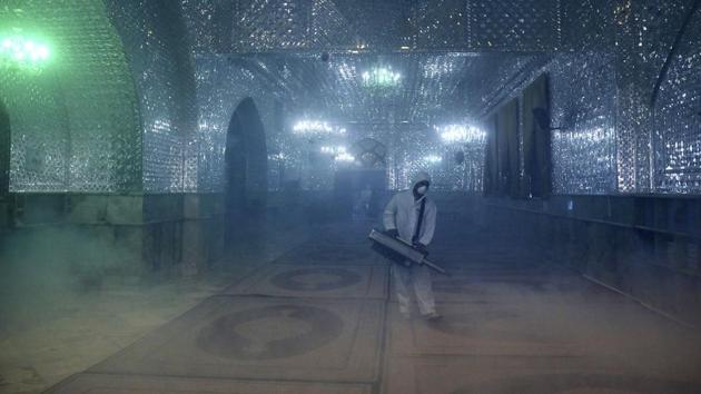 A firefighter disinfects a shrine to help prevent the spread of the new coronavirus in northern Tehran, on March 6.(AP Photo)