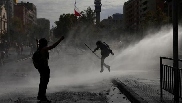 Demonstrators clash with security forces during a protest against Chile's government in Santiago, Chile. (Pablo Sanhueza / REUTERS) Demonstrators clash with security forces during a protest against Chile's government in Santiago, Chile. (Pablo Sanhueza / REUTERS)