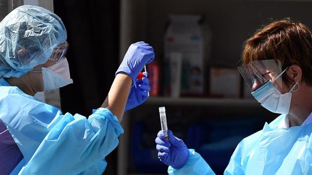 Medical workers at Kaiser Permanente French Campus test a patient for the novel coronavirus, COVID-19, at a drive-thru testing facility in San Francisco, California on March 12, 2020.(AFP) Medical workers at Kaiser Permanente French Campus test a patient for the novel coronavirus, COVID-19, at a drive-thru testing facility in San Francisco, California on March 12, 2020.(AFP)