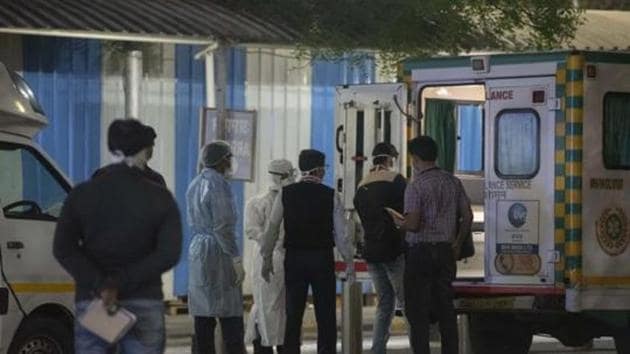 Medical staff stand outside the Pune International airport to take suspected passengers to the hospital, March 14, 2020(Pratham Gokhale/HT Photo)