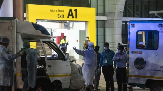 A team of medical staff stand outside ambulances at Pune International airport at Lohgaon to take suspected passengers of Dubai-Pune SpiceJet SG52 flight to government’s quarantine facility on Friday. (Pratham Gokhale/HT Photo) A team of medical staff stand outside ambulances at Pune International airport at Lohgaon to take suspected passengers of Dubai-Pune SpiceJet SG52 flight to government’s quarantine facility on Friday. (Pratham Gokhale/HT Photo)