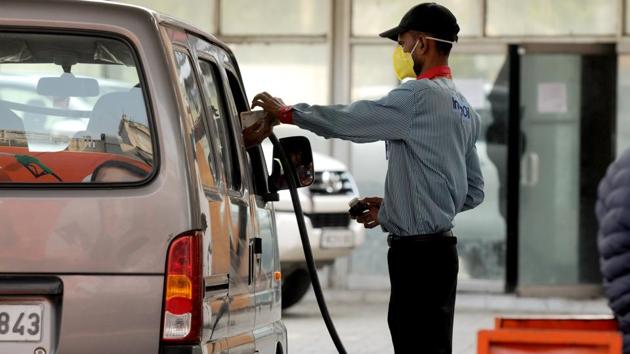 Indian oil petrol pump employee fill petrol in a car. (Parveen Kumar/Hindustan Times)