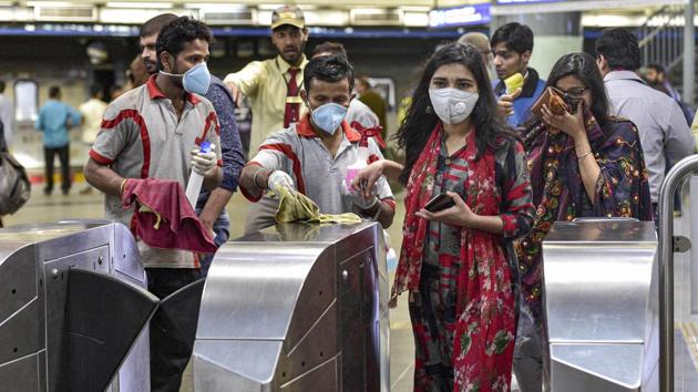Workers clean entry gates at Rajeev Chowk metro station in the wake of novel coronavirus (COVID-19) outbreak.(PTI Photo) Workers clean entry gates at Rajeev Chowk metro station in the wake of novel coronavirus (COVID-19) outbreak.(PTI Photo)