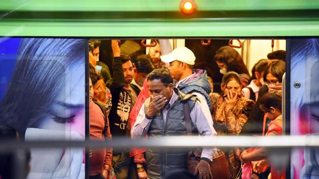 Commuters seen wearing protective masks as a precautionary measure against coronavirus. (Raj K Raj/HT PHOTO) Commuters seen wearing protective masks as a precautionary measure against coronavirus. (Raj K Raj/HT PHOTO)