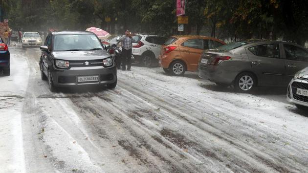 A view of a road littered with hailstones around Rohini area. Delhi was in for a surprise when unseasonal rain and hailstorm lashed parts of the national capital region on Saturday. (HT Photo) A view of a road littered with hailstones around Rohini area. Delhi was in for a surprise when unseasonal rain and hailstorm lashed parts of the national capital region on Saturday. (HT Photo)