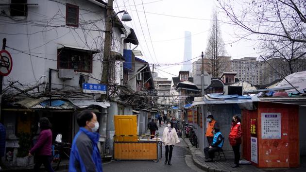 People wear protective face masks at a residential community following an outbreak of coronavirus (COVID-19), in downtown Shanghai, China.(REUTERS) People wear protective face masks at a residential community following an outbreak of coronavirus (COVID-19), in downtown Shanghai, China.(REUTERS)