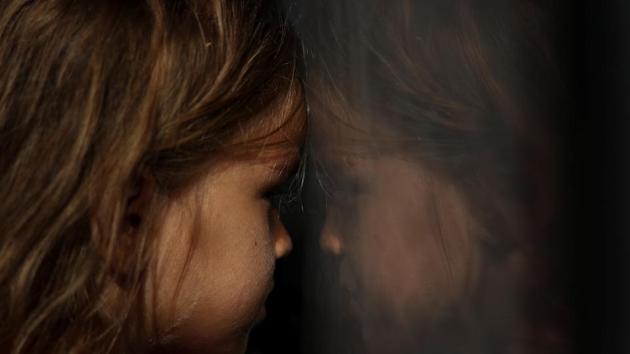 Anna, 5, from Honduras, sits in the back of a border patrol vehicle after being apprehended along with a group of other migrants from Central America who were hiding in thick bush after they crossed into the United States from Mexico, in Mission, Texas. (Adrees Latif / REUTERS)