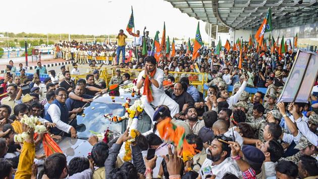 BJP leader Jyotiraditya Scindia being welcomed by his supporters on his arrival at Bhopal Airport. (PTI) BJP leader Jyotiraditya Scindia being welcomed by his supporters on his arrival at Bhopal Airport. (PTI)