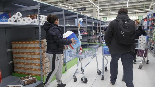 Shoppers load up with toilet rolls, immediately after opening at an Asda supermarket, operated by Walmart Inc. in Portsmouth, U.K., on Saturday. (Bloomberg Photo) Shoppers load up with toilet rolls, immediately after opening at an Asda supermarket, operated by Walmart Inc. in Portsmouth, U.K., on Saturday. (Bloomberg Photo)
