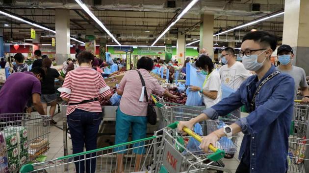 Coronavirus outbreak: Customers, wearing protective masks, shop at a supermarket, following the outbreak of coronavirus, in Kuala Lumpur. (REUTERS) Coronavirus outbreak: Customers, wearing protective masks, shop at a supermarket, following the outbreak of coronavirus, in Kuala Lumpur. (REUTERS)
