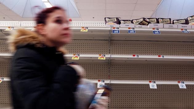 A woman walks past empty shelves, after further cases of coronavirus were confirmed in New York, at a Stop & Shop store in Port Washington, New York. (Shannon Stapleton / REUTERS)
