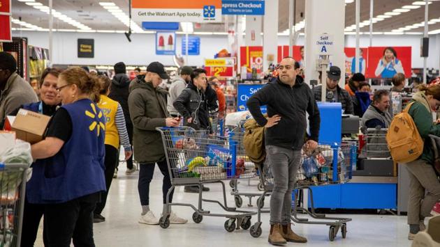 People shop at a Walmart Supercentre amid coronavirus fears spreading in Toronto, Ontario, Canada. (Carlos Osorio / REUTERS) People shop at a Walmart Supercentre amid coronavirus fears spreading in Toronto, Ontario, Canada. (Carlos Osorio / REUTERS)
