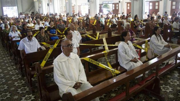 Catholic faithfuls sit on chairs with yellow line tapes, to prevent church goers from sitting close to each other, as part of social distancing at a church in Borongan town, Eastern Samar province, central Philippines. The worst-hit nation after China is still Italy with 1,441 deaths for 21,157 cases, followed by Iran with 611 fatalities (12,729 cases), Spain, with 183 deaths for 5,753 cases, and France, with 91 deaths and 4,499 cases. (Alren BERONIO / AFP) 
