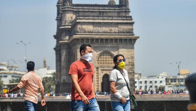 Tourists wear protective masks in view of coronavirus pandemic at Gateway of India in Mumbai.(PTI) Tourists wear protective masks in view of coronavirus pandemic at Gateway of India in Mumbai.(PTI)