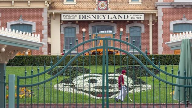 An employee cleans the grounds behind the closed gates of Disneyland Park on the first day of the closure of Disneyland and Disney California Adventure theme parks as fear of the spread of coronavirus continue, in Anaheim, California. The number of novel coronavirus cases globally stood at 154,620 with 5,796 deaths, across 139 countries and territories on Sunday, according to a tally compiled by AFP from official sources. (DAVID MCNEW / AFP) An employee cleans the grounds behind the closed gates of Disneyland Park on the first day of the closure of Disneyland and Disney California Adventure theme parks as fear of the spread of coronavirus continue, in Anaheim, California. The number of novel coronavirus cases globally stood at 154,620 with 5,796 deaths, across 139 countries and territories on Sunday, according to a tally compiled by AFP from official sources. (DAVID MCNEW / AFP)