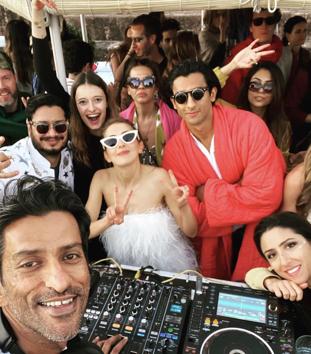 Pacho (in red), Claire (in white) and other guests with DJ Vishal Shetty at the after party.