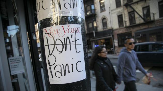 People walk past a convenient store where the latest cover of a magazine is stuck on a pillar outside of it.(AP Photo)