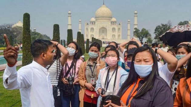Tourist wear protective masks in wake of the deadly novel coronavirus, at Taj Mahal, in Agra. (PTI file photo) Tourist wear protective masks in wake of the deadly novel coronavirus, at Taj Mahal, in Agra. (PTI file photo)