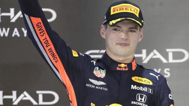 Red Bull driver Max Verstappen holds the trophy on the podium after he placed second in the Emirates Formula One Grand Prix.(AP)