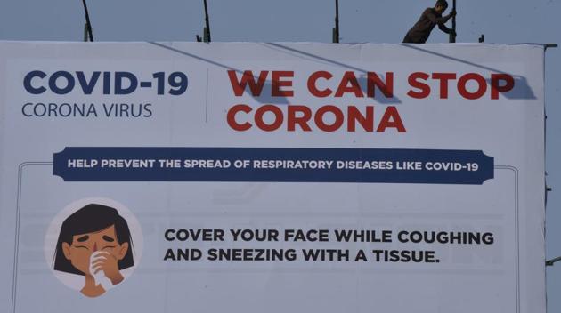 A worker fixes a billboard on coronavirus at Juhu in Mumbai, Monday, March 16, 2020. (Pramod Thakur / HT Photo) A worker fixes a billboard on coronavirus at Juhu in Mumbai, Monday, March 16, 2020. (Pramod Thakur / HT Photo)
