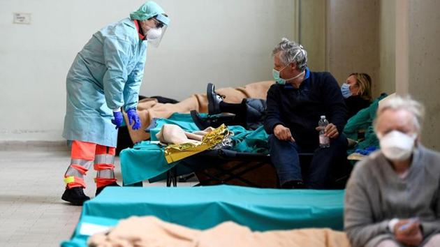 Medical personnelasks help patients inside the Spedali Civili hospital in Brescia. Over three weeks, 1,135 people have needed intensive care in Lombardy, but the region has only 800 intensive care beds, according to Giacomo Grasselli, head of the ICU at Milan’s Policlinico hospital, separate from San Donato. Grasselli coordinates all the state-run intensive care units across Lombardy. (Flavio Lo Scalzo / REUTERS) Medical personnelasks help patients inside the Spedali Civili hospital in Brescia. Over three weeks, 1,135 people have needed intensive care in Lombardy, but the region has only 800 intensive care beds, according to Giacomo Grasselli, head of the ICU at Milan’s Policlinico hospital, separate from San Donato. Grasselli coordinates all the state-run intensive care units across Lombardy. (Flavio Lo Scalzo / REUTERS)