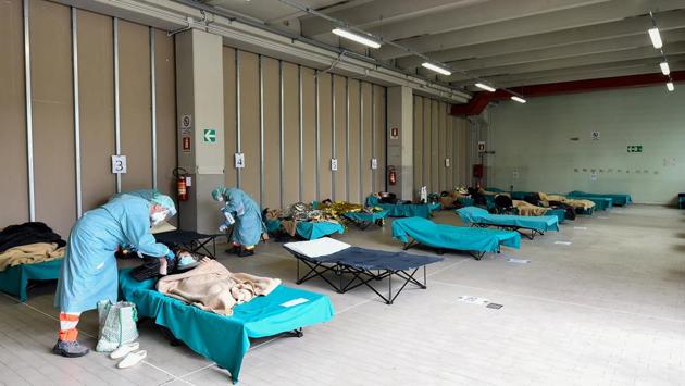 Hospital employees tend to patients at a temporary structure set up outside the accident and emergency department, where any new arrivals presenting coronavirus symptoms are being tested, at the Brescia hospital, Lombardy. As of Monday, 2,158 people had died and 27,980 been infected by coronavirus in Italy – the second highest number of reported cases and deaths in the world behind China. (Flavio Lo Scalzo / REUTERS) Hospital employees tend to patients at a temporary structure set up outside the accident and emergency department, where any new arrivals presenting coronavirus symptoms are being tested, at the Brescia hospital, Lombardy. As of Monday, 2,158 people had died and 27,980 been infected by coronavirus in Italy – the second highest number of reported cases and deaths in the world behind China. (Flavio Lo Scalzo / REUTERS)
