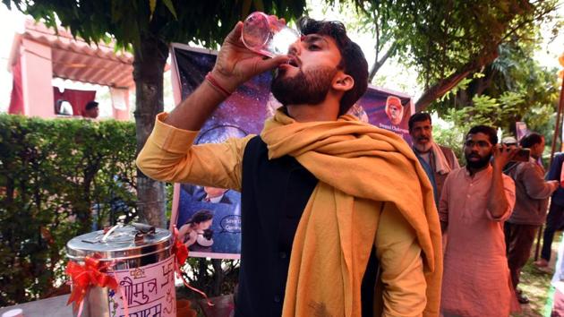 People drink cow urine at an event organized by a religious group to promote consumption of cow urine to fight the spread of coronavirus, in New Delhi, on March 14, 2020.(Sonu Mehta/HT Photo)