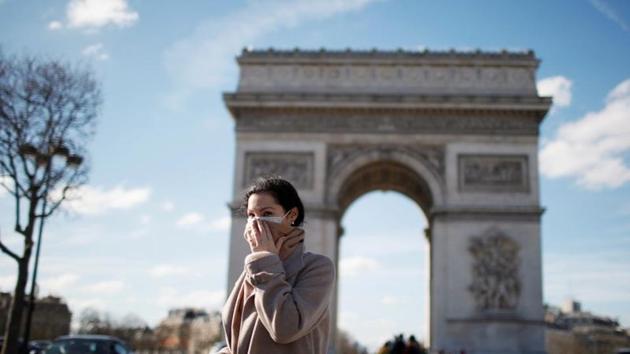 A woman wearing a protective mask, walks near Arc de Triomphe following France's Prime Minister announcement to close most all non-indispensable locations, cafes, restaurants, cinemas, nightclubs and shops as France grapples with an outbreak of coronavirus (COVID-19) disease, in Paris.(REUTERS) A woman wearing a protective mask, walks near Arc de Triomphe following France's Prime Minister announcement to close most all non-indispensable locations, cafes, restaurants, cinemas, nightclubs and shops as France grapples with an outbreak of coronavirus (COVID-19) disease, in Paris.(REUTERS)