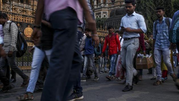 Commuters walk past the Chhatrapati Shivaji Terminus railway station in Mumbai. (Bloomberg) Commuters walk past the Chhatrapati Shivaji Terminus railway station in Mumbai. (Bloomberg)