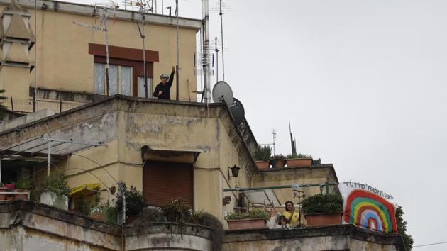 People wave and clap their hands as a banner reading everything will be alright is displayed at right, at the Garbatella neighbourhood, in Rome, Italy. The nationwide lockdown to slow coronavirus is still early days for much of Italy, but Italians are already showing signs of solidarity with flash mob calls circulating on social media for people to gather on their balconies at certain hours, either to play music or to give each other a round of applause. (Alessandra Tarantino / AP) People wave and clap their hands as a banner reading everything will be alright is displayed at right, at the Garbatella neighbourhood, in Rome, Italy. The nationwide lockdown to slow coronavirus is still early days for much of Italy, but Italians are already showing signs of solidarity with flash mob calls circulating on social media for people to gather on their balconies at certain hours, either to play music or to give each other a round of applause. (Alessandra Tarantino / AP)