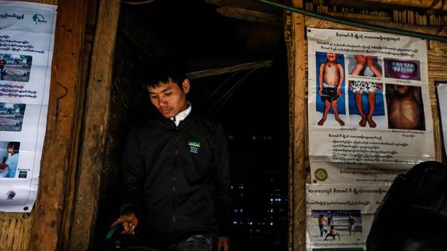 A member of MAM walks past a rickets awareness poster at a community base clinic. The NGO’s army of volunteers has also uncovered a medical anomaly -- a high concentration of rickets. The bone disease, which can result in irreversible limb deformities and stunted growth, is often caused by a lack of vitamin D, obtained in part from sunlight and hardly an expected problem in tropical Myanmar. (Ye Aung Thu / AFP)