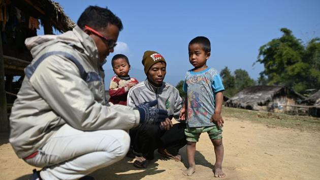 MAM) doctor Zaw Min Lay (L) talks to a father, whose son has rickets (R), in Tow Law village. “Language, transportation and zero telecommunications are the major challenges,” explained Zaw Min Lay. The trainees offer a lifeline -- however basic -- for communities, especially in the rainy season when mud and landslides can leave villages completely marooned. (Ye Aung Thu / AFP)