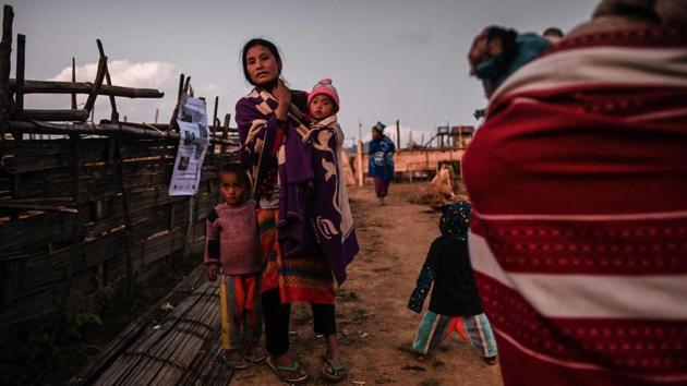 Members of a Naga tribe wait for a mobile clinic to open in Khar Lay village. “We have no motorbikes and no money to pay for a motorbike taxi,” farmer Mon, 30, visibly relieved after testing negative for malaria in Toe Lawt village told AFP. Improved rural health services are largely credited for driving down malaria across Myanmar by more than 90% between 2010 and 2017, World Health Organization (WHO) figures show. (Ye Aung Thu / AFP)