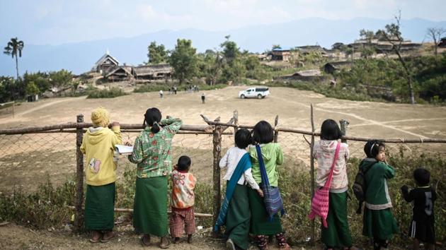Young members of a Naga tribe watch as a team from MAM arrives to open a mobile clinic in Khar Lay village in Lahe township. The NGO’s success lies primarily in its network of health volunteers. One person in each of the area’s 275 villages has been trained to distribute basic medicines, from painkillers to rehydration salts, screen for TB, and -- crucially -- conduct malaria tests. (Ye Aung Thu / AFP)