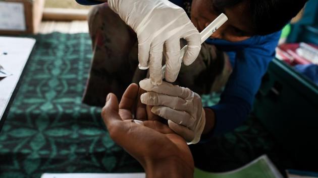 Htan Pi conducts a malaria test. Patients give a drop of blood and receive a result in just 15 minutes, flagging cases of the often fatal sickness early. The organisation provides transport to the nearest hospital for anyone needing emergency help, saving excruciating journeys by foot. (Ye Aung Thu / AFP)