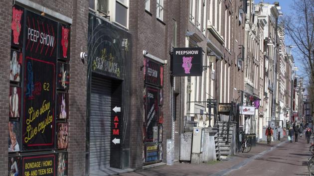 The narrow canal-side streets and alleys of Amsterdam's famed Red Light District, normally packed with tourists, were largely deserted.(AP)