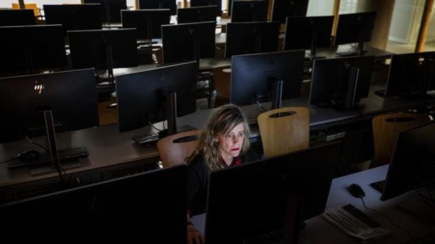 A teacher works in an empty classroom at the Pompeu Fabra university in Barcelona, Spain. Spain set up police checks at its land borders with France and Portugal on Tuesday and turned back foreigners attempting to enter, part of strict measures to prevent the spread of the coronavirus in Europe’s second hardest-hit country. The government has sent home nearly 10 million students and asked people to work remotely. (Emilio Morenatti / AP) A teacher works in an empty classroom at the Pompeu Fabra university in Barcelona, Spain. Spain set up police checks at its land borders with France and Portugal on Tuesday and turned back foreigners attempting to enter, part of strict measures to prevent the spread of the coronavirus in Europe’s second hardest-hit country. The government has sent home nearly 10 million students and asked people to work remotely. (Emilio Morenatti / AP)