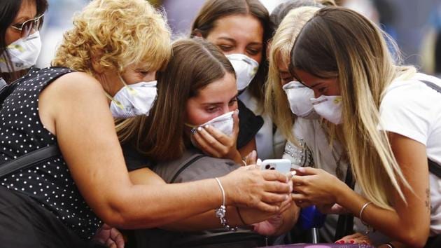 Travellers wearing protective masks look at a smart phone at the Ministro Pistarini International Airport, in Ezeiza on the outskirts of Buenos Aires. Argentina has published a decree establishing a 30-day ban on entry to non-residents who have travelled to a country highly affected by coronavirus in the last 14 days. (Marcos Brindicci / AP) Travellers wearing protective masks look at a smart phone at the Ministro Pistarini International Airport, in Ezeiza on the outskirts of Buenos Aires. Argentina has published a decree establishing a 30-day ban on entry to non-residents who have travelled to a country highly affected by coronavirus in the last 14 days. (Marcos Brindicci / AP)