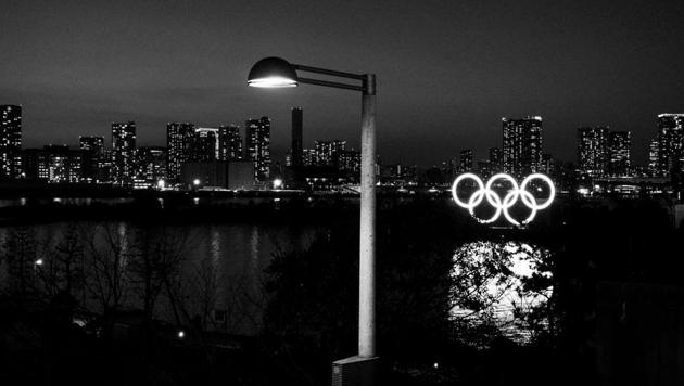 Illuminated Olympic rings float in the water in the Odaiba section of Tokyo(AP)