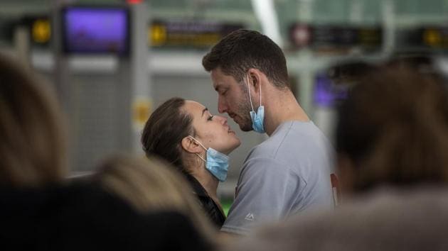 A couple kiss, at the Barcelona Airport, Spain, Thursday. Airlines and travellers were left sorting out the new travel ban that President Donald Trump announced late Wednesday last week, barring most foreign visitors from continental Europe for 30 days. (Emilio Morenatti / AP) A couple kiss, at the Barcelona Airport, Spain, Thursday. Airlines and travellers were left sorting out the new travel ban that President Donald Trump announced late Wednesday last week, barring most foreign visitors from continental Europe for 30 days. (Emilio Morenatti / AP)