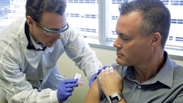 Pharmacist Michael Witte, left, gives Neal Browning a shot in the first-stage study of a potential coronavirus vaccine Monday, March 16, 2020, at the Kaiser Permanente Washington Health Research Institute in Seattle. Browning is the second patient to receive the shot in the study.(AP)