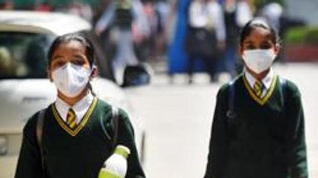 School students wearing protective masks as a precautionary measure against coronavirus, as they exit after a CBSE Board Examination at Green Park in New Delhi.(Amal KS/HT PHOTO)