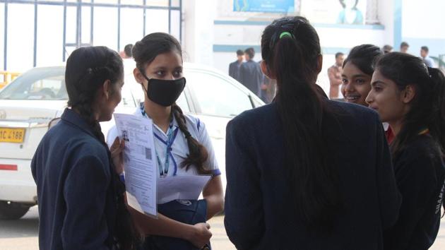 A girl is seen wearing a protective mask as students of class 10th arrive to appear for their CBSE exam, at an examination centre, Sector 10, in Gurugram, India, on Wednesday. (Yogendra Kumar/HT PHOTO)