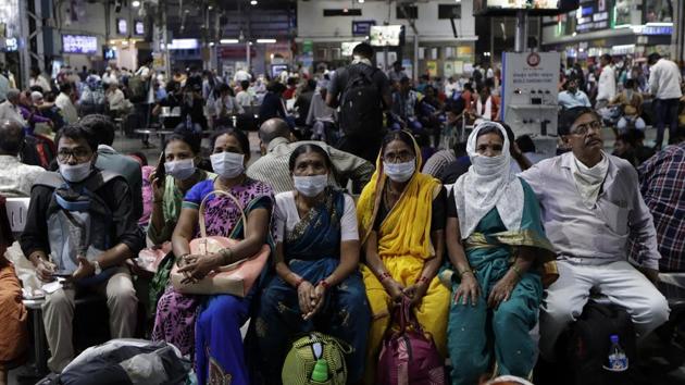 Passengers waiting at a train station wear protective masks as a precaution against a new virus outbreak in Mumbai, Tuesday, March 17, 2020. (AP) Passengers waiting at a train station wear protective masks as a precaution against a new virus outbreak in Mumbai, Tuesday, March 17, 2020. (AP)