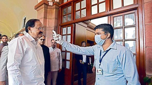 A security official checks the temperature of vice president M Venkaiah Naidu with an infrared thermometer at the Parliament House, March 18, 2020. (Sonu Mehta / HT Photo) A security official checks the temperature of vice president M Venkaiah Naidu with an infrared thermometer at the Parliament House, March 18, 2020. (Sonu Mehta / HT Photo)