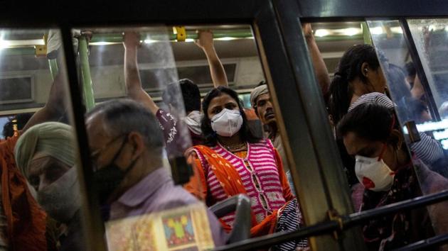 Commuters wearing protective masks as a precaution against the spread of coronavirus disease Covid-19, travel in a crowded bus in New Delhi on March 18.(Reuters Photo)