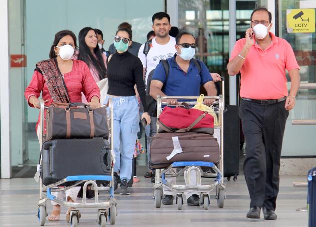 Passengers wearing masks as a precautionary measure against coronavirus at the Chandigarh International Airport on Wednesday.(Gurminder Singh/HT)