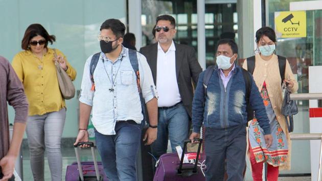 Passengers seen wearing safety masks as they come out of the international airport in Mohali.(Gurminder Singh/Hindustan Times)