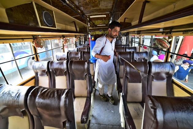 A worker sanitising a bus at the ISBT in Ludhiana on Thursday.(Gurpreet Singh/HT)